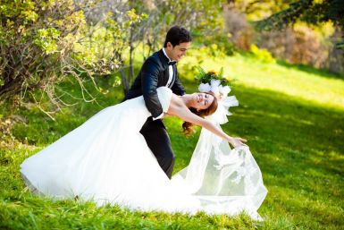 8744379 - dancing wedding couple at a park on a sunny day