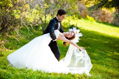 8744379 - dancing wedding couple at a park on a sunny day