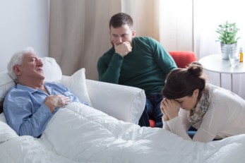 38232886 - dying man lying in bed and his despaired children